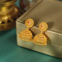 A pair of traditional Gold Jhumka earrings.